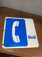 Front side of Bell telephone metal sign showing handset graphic and Bell text