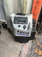Front view of Blue Ox Patriot unit showing branding and attached power cord