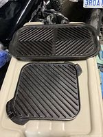 Square Lodge cast iron grill atop rectangular Nordic Ware grill showing ridged sides and overall dimensions.