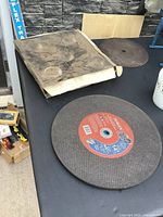 Box of Stihl cut-off wheels with loose wheels visible