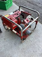 Overall view of Hale water pump inside carry frame showing engine, pump housing, and intake/outlet fitting