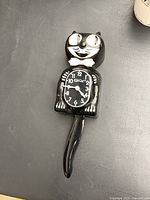 Full view of Kit Cat Klock front showing face, dial, and tail