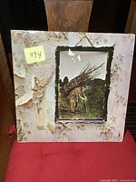 Front of gatefold jacket displaying artwork and wear