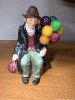 Front view of Royal Doulton The Balloon Man figurine showing colours, attire and balloons