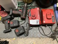 Both cordless tools, two batteries, two chargers arranged on floor