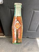 Front of metal RC Cola bottle sign with logo and painted beverage graphics