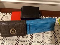 All three wallets showing front exteriors with two storage boxes