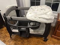 Overall view of playard with attached changing station and organizer caddy