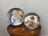 Both plates on display stands to show full designs