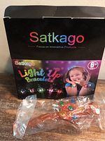 Closed retail box with one bracelet in plastic sleeve