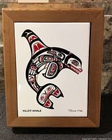 Full view of wood-framed ceramic tile with killer whale design
