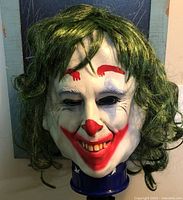 Front view of Joker style mask on stand