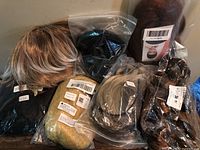 Group of seven sealed wigs in various colors