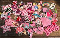 Overview of assorted embroidered patches spread out on table
