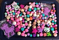 Tray of assorted silicone beads showing variety of shapes and colours