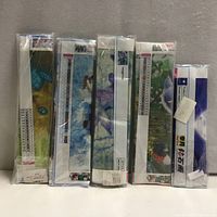 Front view of five rolled diamond painting kits in plastic