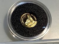 Coin in capsule showing reverse with arctic hare, text CANADA 2017 25 CENTS visible