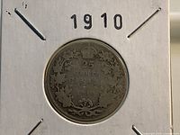 Reverse side showing 1910 date and wreath design