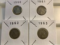 Four Canadian dimes dated 1960-1963 in holders, reverse side showing Bluenose Schooner