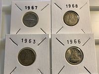 Obverse view of four dimes in holders showing dates 1967, 1968, 1963, 1966