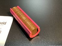 Dispenser laid horizontally with visible stack of pennies