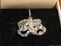 Front view of sterling silver comedy and tragedy masks charm