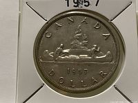 Reverse of 1957 Canada silver dollar in holder