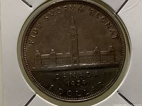 Reverse of coin showing Parliament Buildings and inscriptions