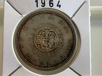 Reverse of 1964 Charlottetown-Quebec silver dollar in holder