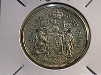 Reverse of 1960 Canadian 50 cent coin showing coat of arms