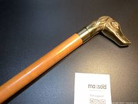 Close-up of brass dog-head handle and shaft