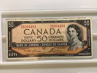 Front of 1954 $50 note showing serial number and portrait