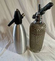 Front view of both soda syphons side by side