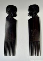 Front view of both carved wooden African combs