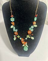 Full view of necklace on display bust showing overall design and pendant