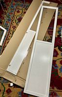 Full door frame and lower panel laid on packaging