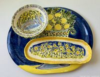 Top view of all three ceramic pieces showing primary painted designs