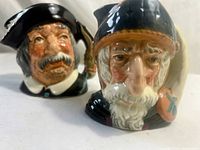 Front view of both jugs showing faces and handles