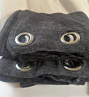 Folded panels showing silver grommets