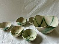 Set of six pottery bowls showing relative sizes and green streak pattern