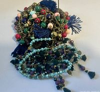 Pile view of both necklaces showing tassels and bead colours