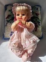 Full view of doll seated showing complete outfit