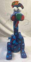 Front view of blue polka-dot cat sculpture showing full form