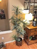 full view of planter on legs with artificial plant