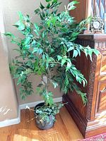 Full view of artificial potted plant by cabinet