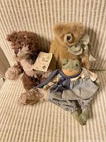 Group shot: tan bear, brown bear, frog doll on chair