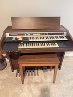 Front view of Hammond console organ with pedals and bench