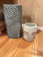 Front view showing both planters, detailing floral relief and size difference