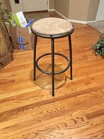Full view of stool showing metal frame and padded seat
