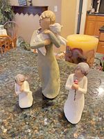 Front view of three figurines on countertop
